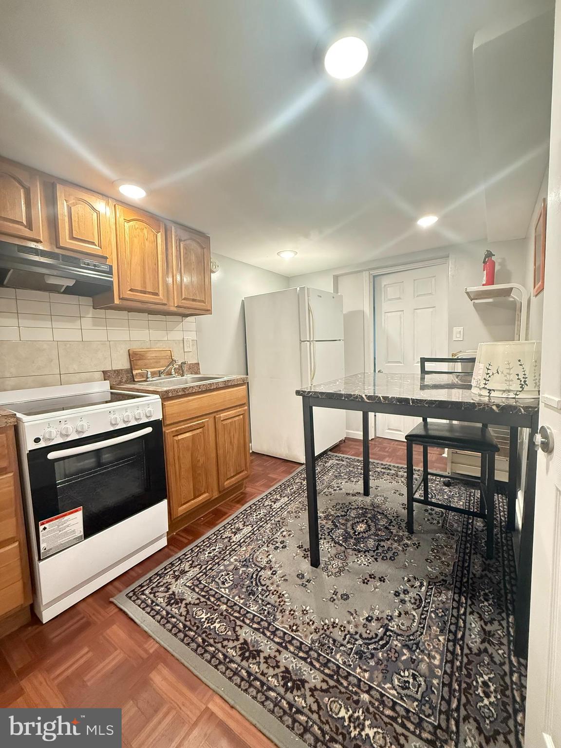 a kitchen with a stove a sink and a refrigerator