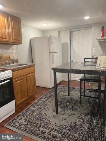 a kitchen with a table chairs and a window