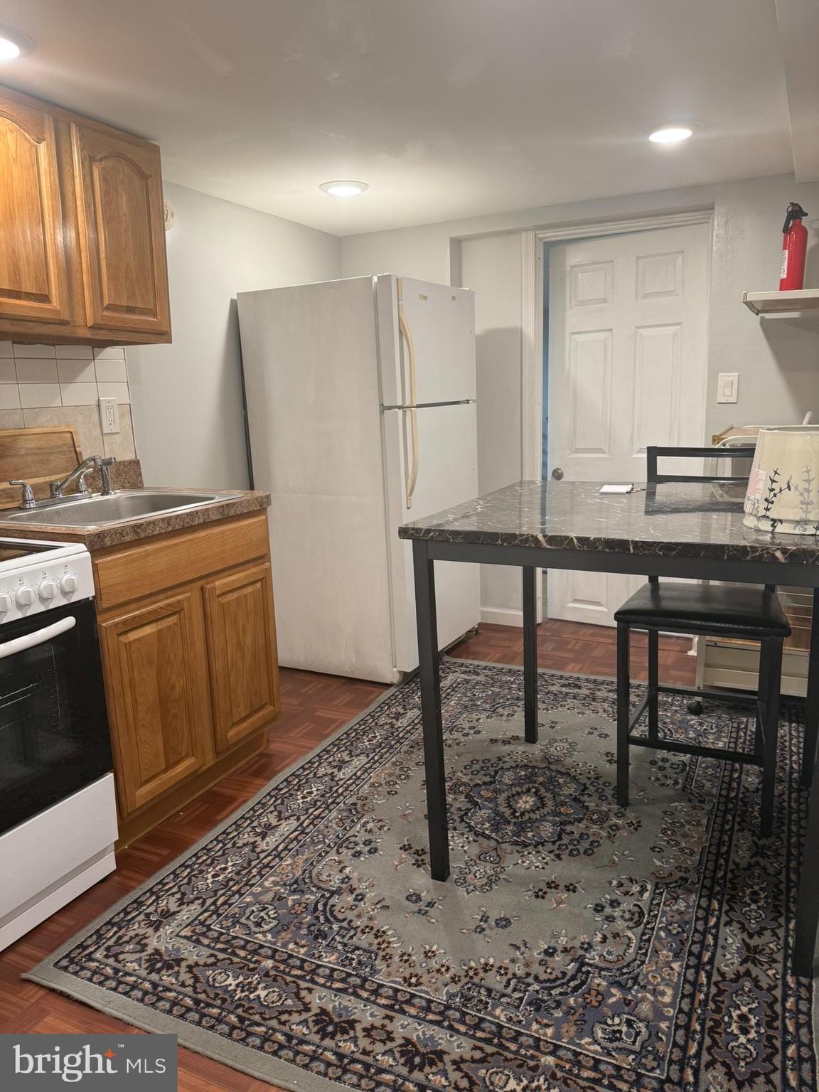 7547 Beverly Road Philadelphia, PA 19138 - Photo 23 of 32 a kitchen with stainless steel appliances granite countertop a table chairs sink and cabinets