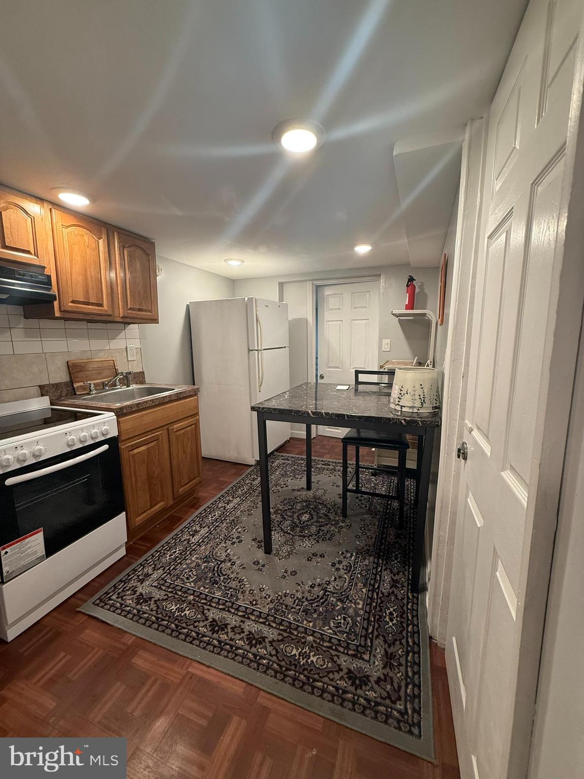 7547 Beverly Road Philadelphia, PA 19138 - Photo 24 of 32 a kitchen with a sink a stove and cabinets
