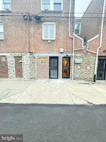 a front view of a house with a road