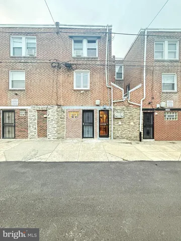 a front view of a house with swimming pool and furniture