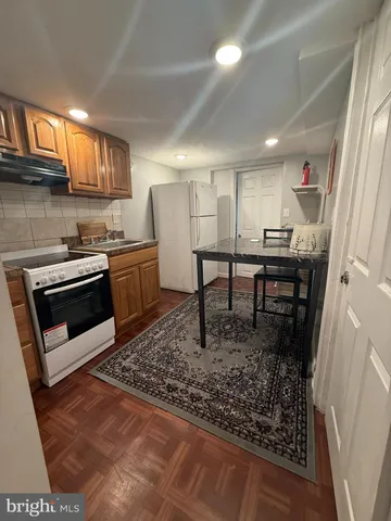 a kitchen with a stove a sink and a refrigerator