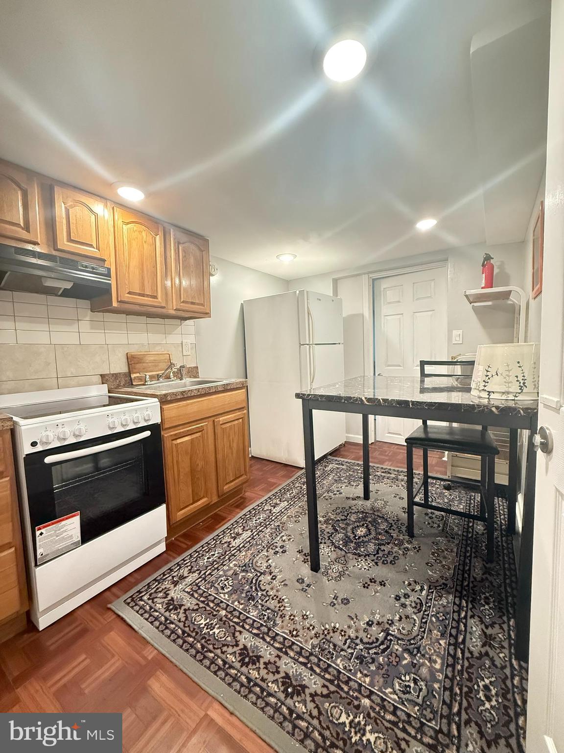 7547 Beverly Road Philadelphia, PA 19138 - Photo 10 of 32 a kitchen with a stove a sink and a refrigerator