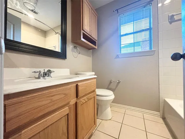 a bathroom with a sink a toilet and a window
