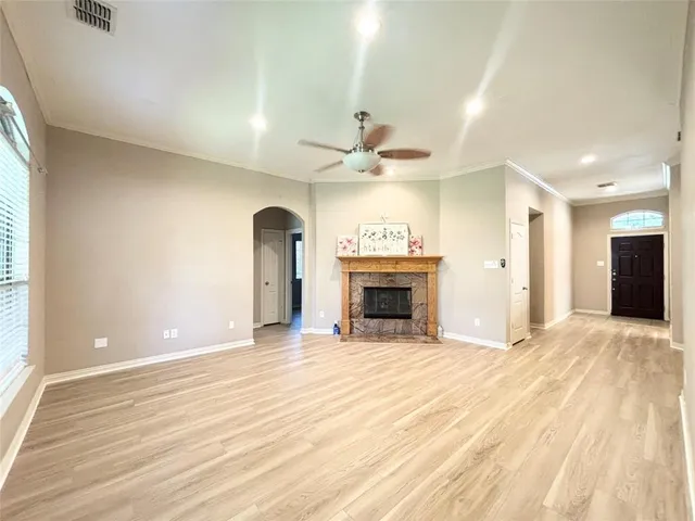 a view of an empty room with a fireplace and a window