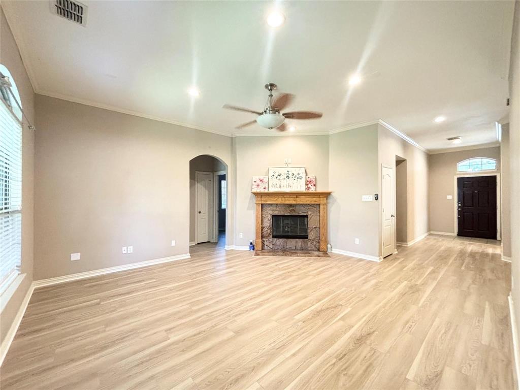 9416 Harrell Drive McKinney, TX 75072 - Photo 14 of 16 a view of an empty room with a fireplace and a window