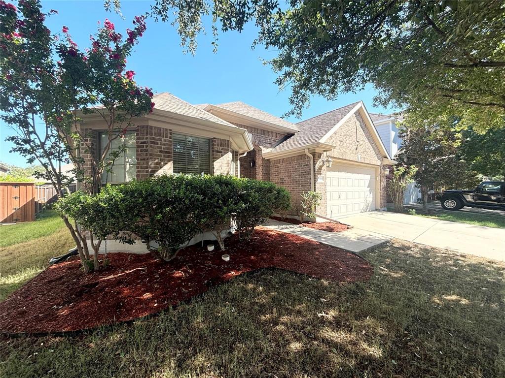 9416 Harrell Drive McKinney, TX 75072 - Photo 3 of 16 a front view of a house with a yard and garage