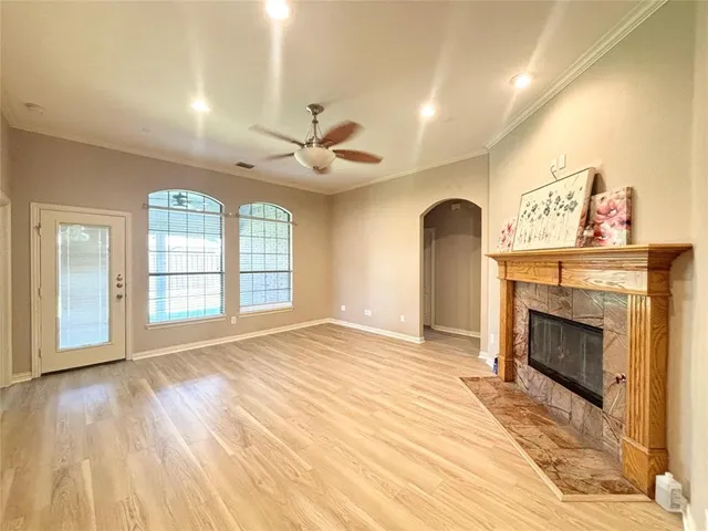 a view of an empty room with a fireplace and a window