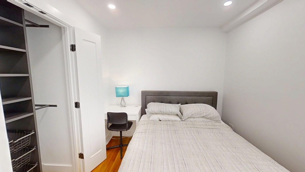 36 Shepard Street, Unit 1 Boston, MA 02135 - Photo 12 of 29 a bedroom with a bed and a refrigerator