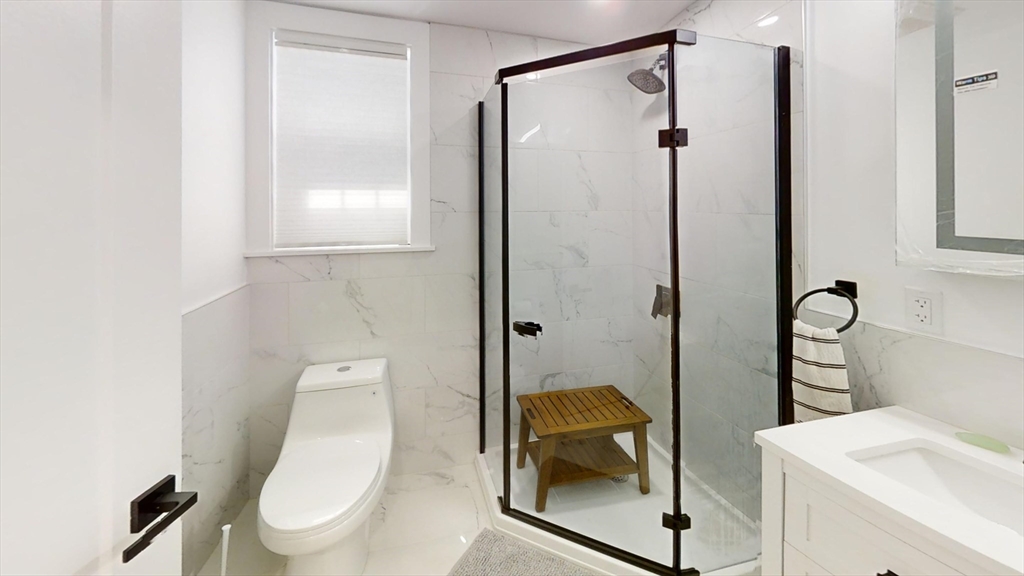 36 Shepard Street, Unit 1 Boston, MA 02135 - Photo 15 of 29 a bathroom with a toilet a sink and shower