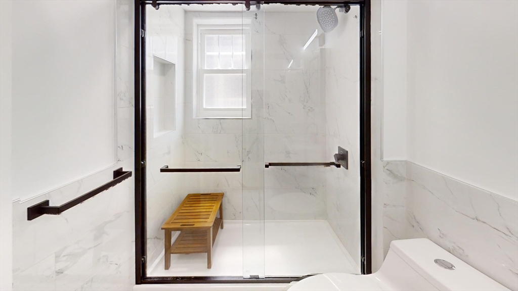 36 Shepard Street, Unit 1 Boston, MA 02135 - Photo 16 of 29 a bathroom with a window and a shower