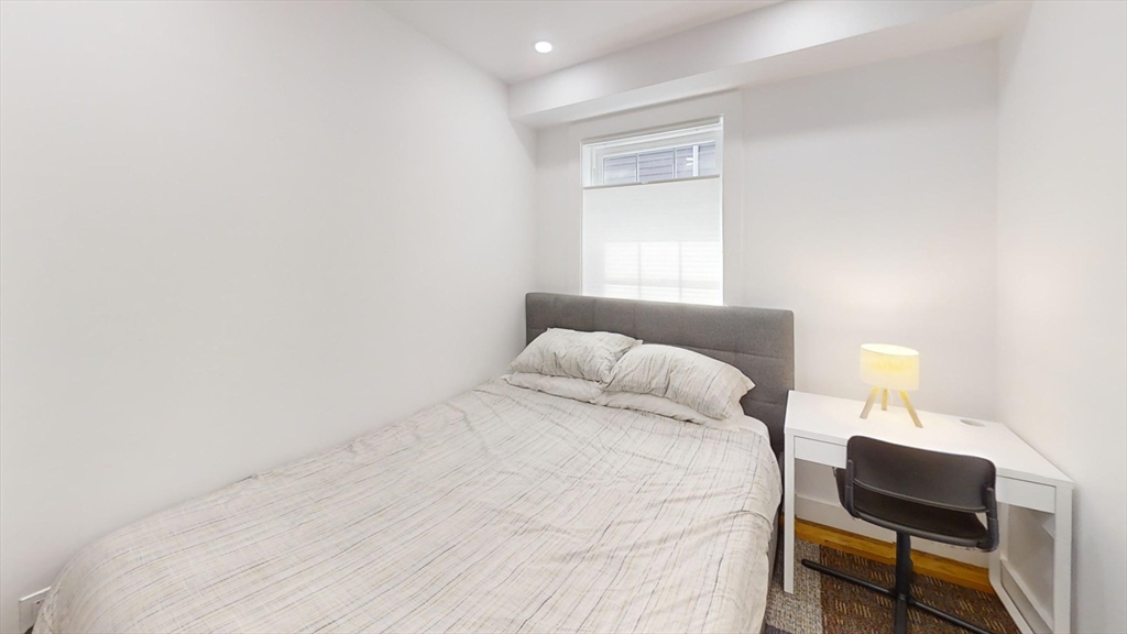 36 Shepard Street, Unit 1 Boston, MA 02135 - Photo 17 of 29 a bedroom with a bed and a lamp