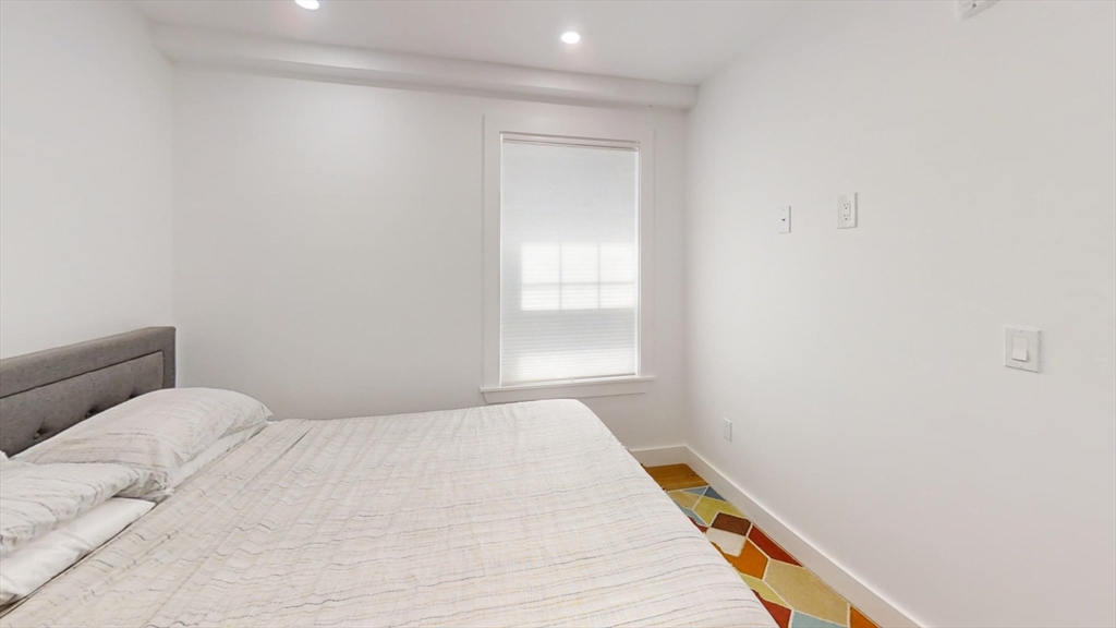 36 Shepard Street, Unit 1 Boston, MA 02135 - Photo 18 of 29 a bedroom with a bed
