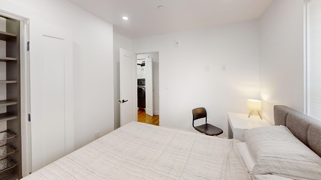 36 Shepard Street, Unit 1 Boston, MA 02135 - Photo 19 of 29 a bedroom with a bed and a lamp