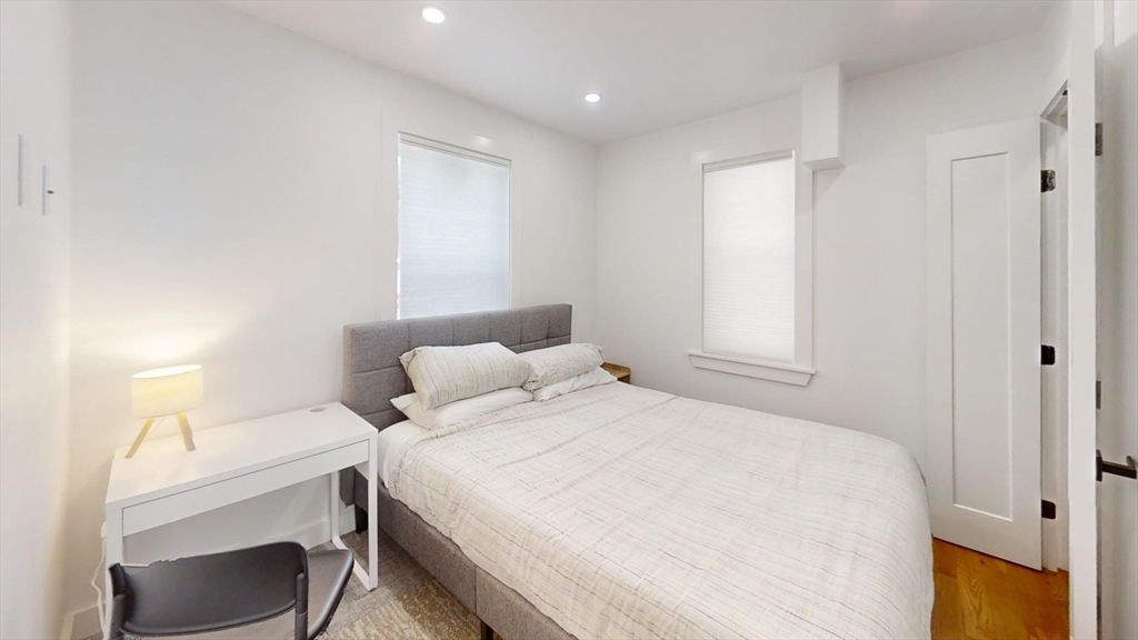 36 Shepard Street, Unit 1 Boston, MA 02135 - Photo 20 of 29 a bedroom with a bed and a table in it