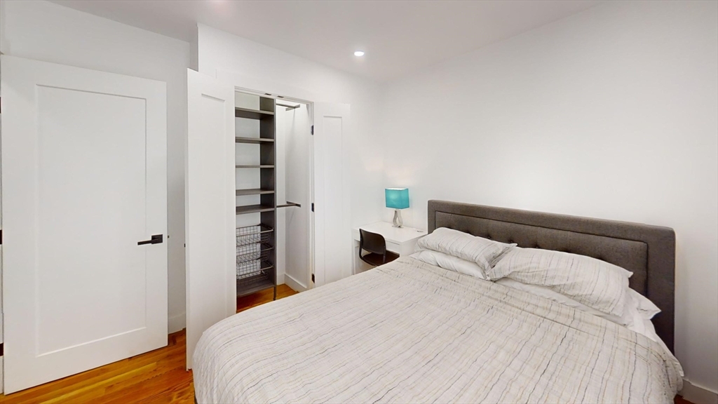 36 Shepard Street, Unit 1 Boston, MA 02135 - Photo 22 of 29 a bedroom with a bed and wooden floor