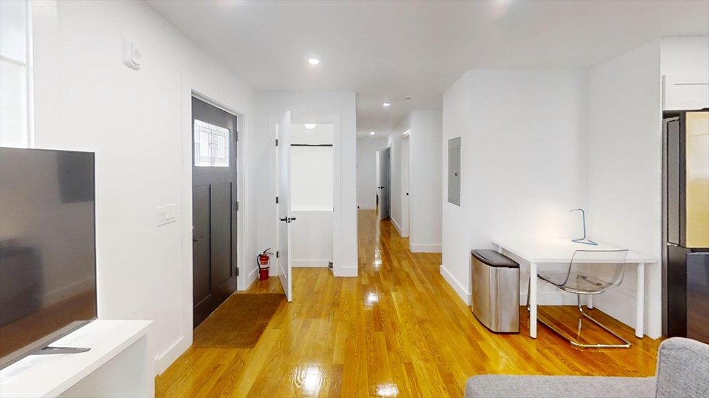 36 Shepard Street, Unit 1 Boston, MA 02135 - Photo 26 of 29 a spacious bedroom with a bed and wooden floor