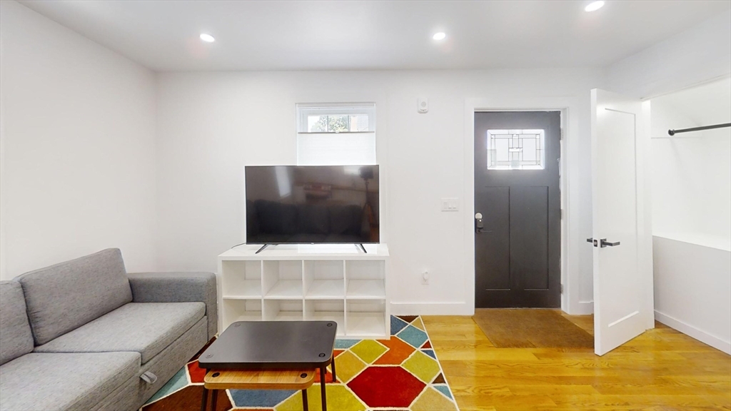 36 Shepard Street, Unit 1 Boston, MA 02135 - Photo 27 of 29 a living room with furniture and a flat screen tv