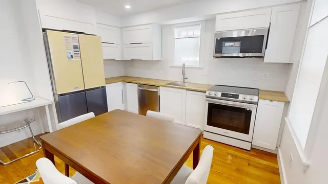 a kitchen with a stove a sink and a microwave