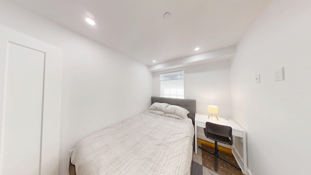 36 Shepard Street, Unit 1 Boston, MA 02135 - Photo 5 of 29 a bedroom with a bed and a tv