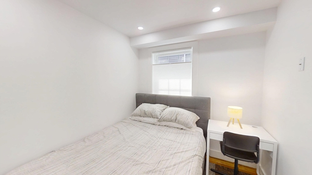 36 Shepard Street, Unit 1 Boston, MA 02135 - Photo 7 of 29 a bedroom with a bed and chair