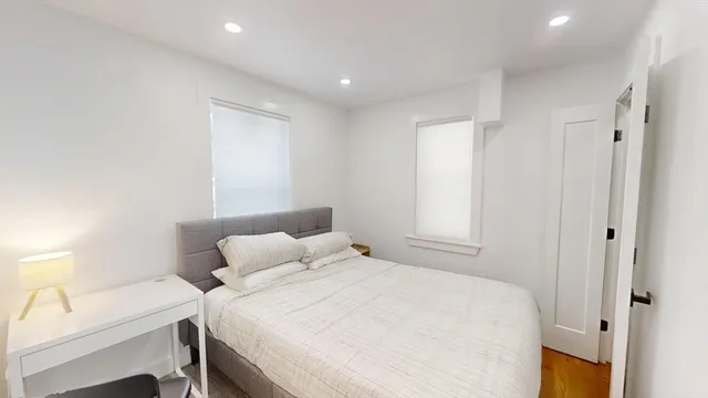 a bedroom with a bed and a table in it