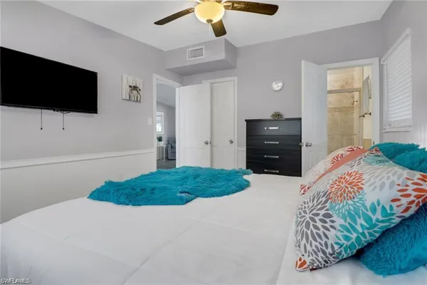 a bedroom with a bed and a flat tv screen