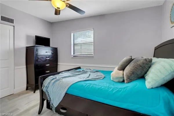 a bedroom with a bed and a tv