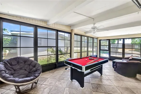 a living room with furniture and a floor to ceiling window