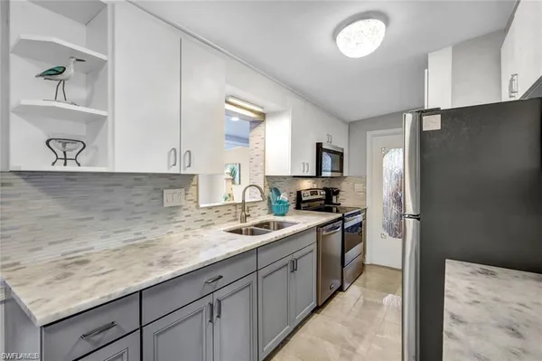 a kitchen with a sink stove and refrigerator