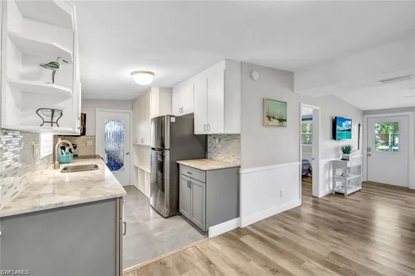 a kitchen with refrigerator and cabinets