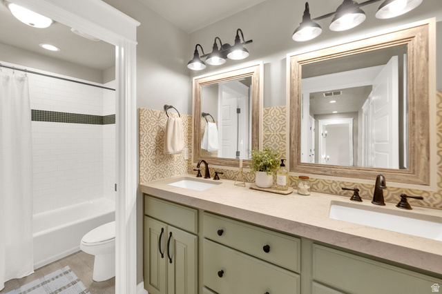 1132 South 1300th Street West Mapleton, UT 84664 - Photo 25 of 52 Dual vanity featuring an integrated sink, light-toned countertop, custom-finish cabinetry, and framed mirrors with industrial-style lighting