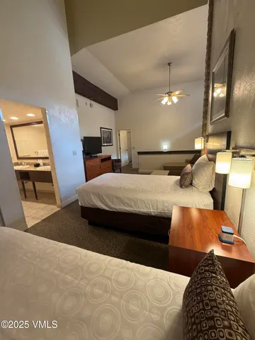 a bedroom with a bed window and couch