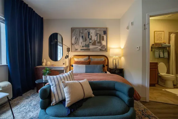 a bedroom with furniture and a painting