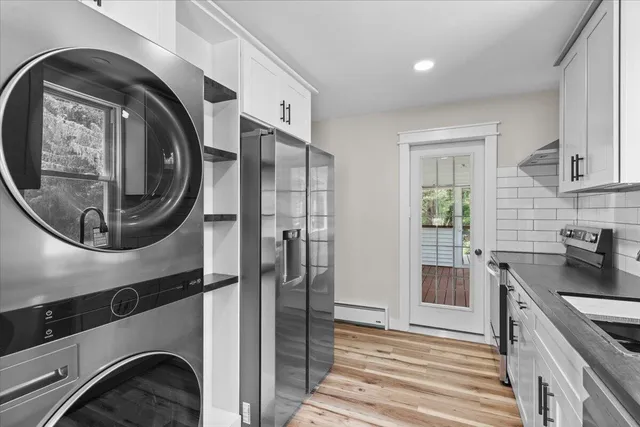 a kitchen with a sink and a washer dryer