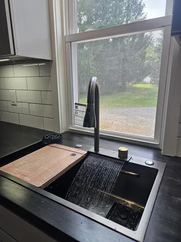 a room with a large window and a rug