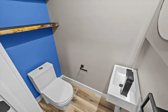 a bathroom with a toilet and a mirror