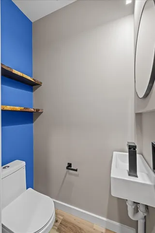 a white toilet sitting next to a bathroom sink