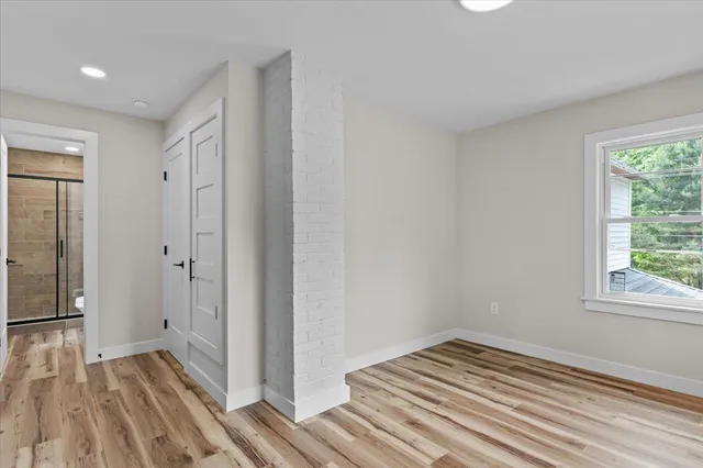 a view of a room with wooden floor and bathroom