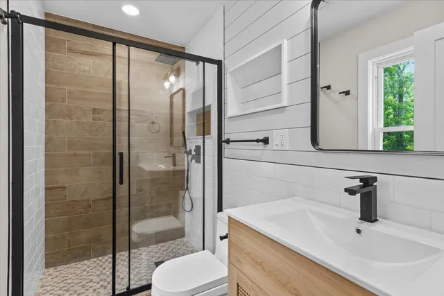 a bathroom with a shower and a sink