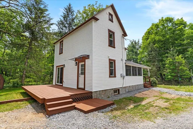 a backyard of a house with yard and outdoor seating