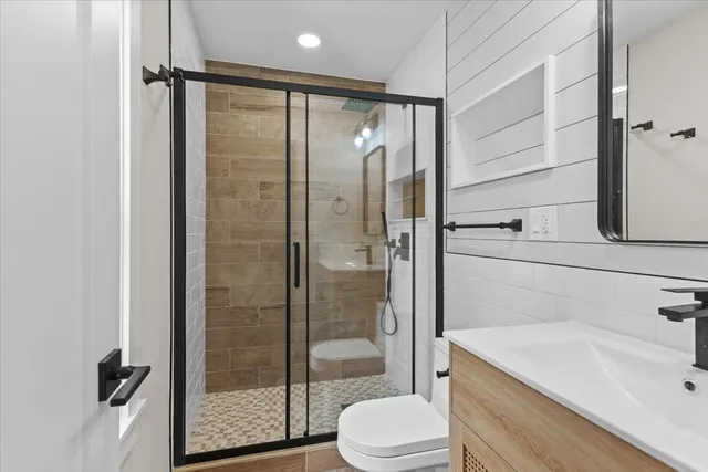 a bathroom with a sink toilet and shower