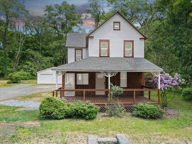 a front view of a house with a yard table and chairs