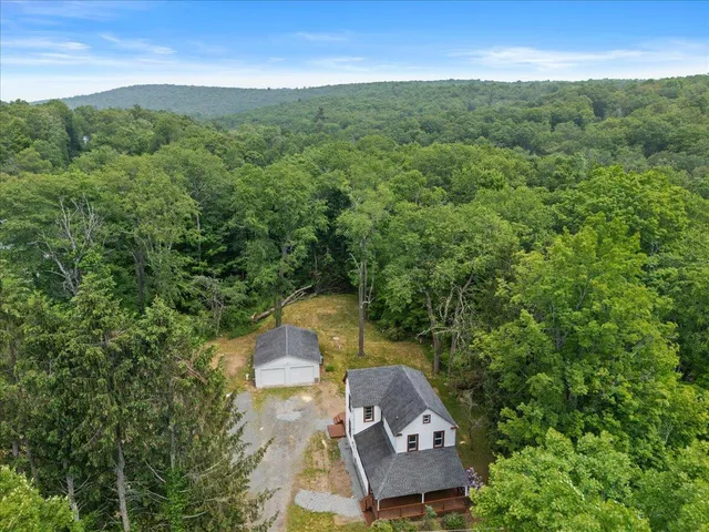 an aerial view of a house with a yard
