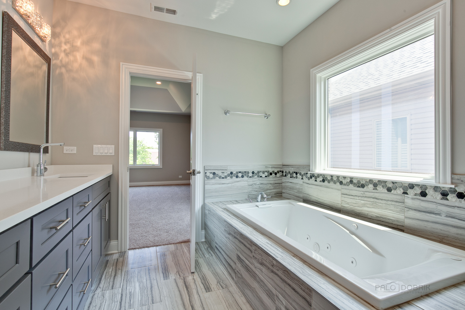 1747 Greenwood Road Glenview, IL 60026 - Photo 29 of 46 a spacious bathroom with a granite countertop tub sink and mirror