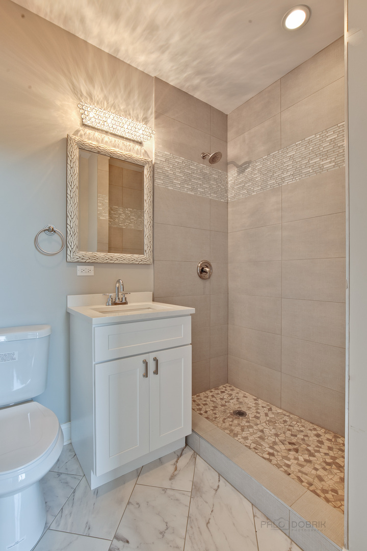 1747 Greenwood Road Glenview, IL 60026 - Photo 35 of 46 a bathroom with a sink a toilet and shower