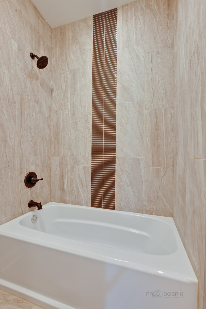 1747 Greenwood Road Glenview, IL 60026 - Photo 38 of 46 a bathroom with a bathtub and a shower