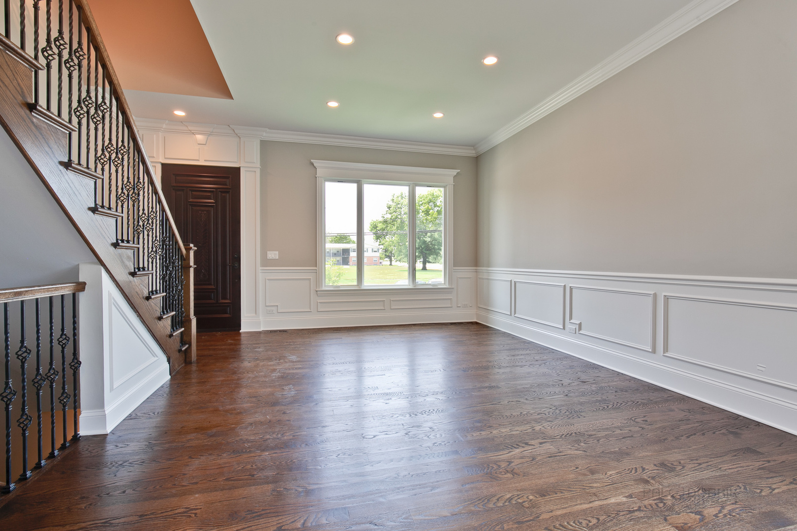 1747 Greenwood Road Glenview, IL 60026 - Photo 9 of 46 an empty room with wooden floor staircase and windows