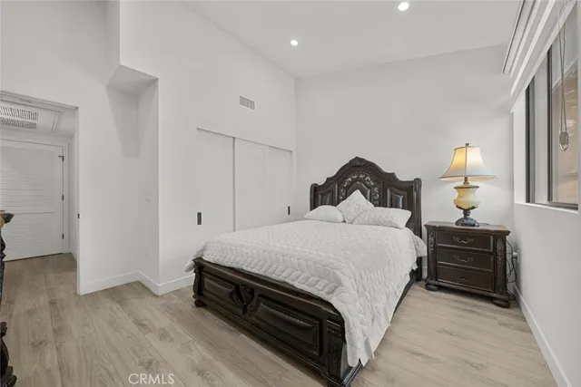 a bedroom with a bed and a dresser